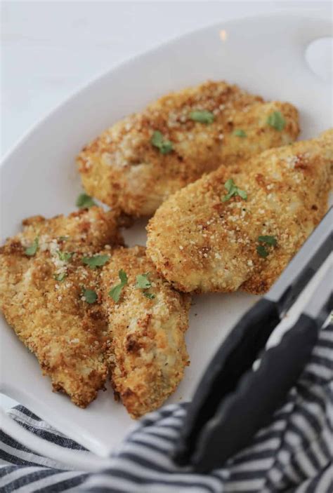 Breaded Chicken Cutlets In Air Fryer After Cooking On A White Platter