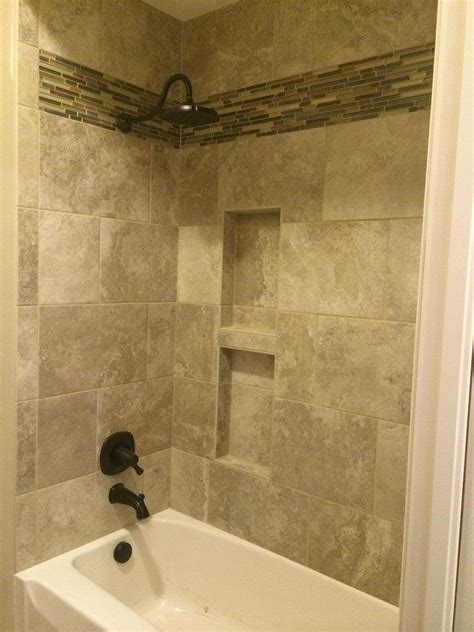 White paneling on the front of the tub sets it apart from the room's rich espresso cabinetry. Very nice tile shower and tub surround by Bob & Pete's ...