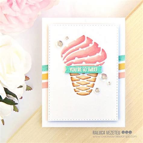 A Card With An Ice Cream Cone On It And Some Flowers In Front Of It