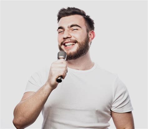 Premium Photo Bearded Man Singing To The Microphone Emotional Portrait Of An Attractive Guy