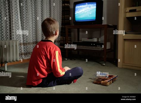 Portrait Of A Young Boy Watching Football On Television Stock Photo Alamy