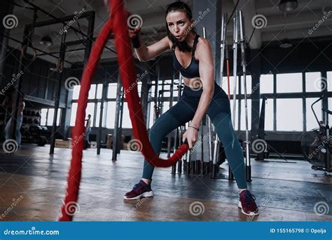 Fit Woman Using Battle Ropes During Strength Training At The Gym Stock Photo Image Of Healthy
