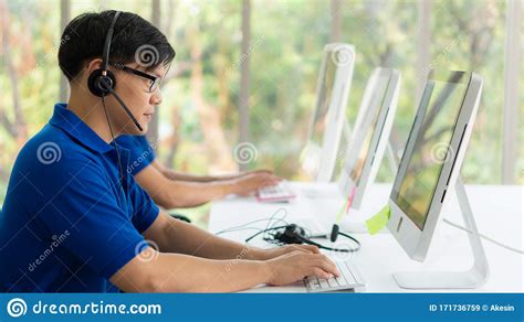 Business Background Of Asian Male Customer Service Agent On Telephone