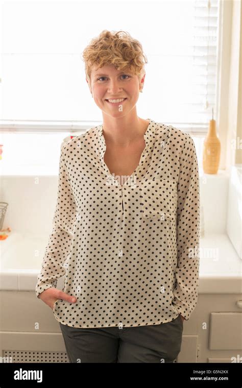Caucasian Woman Smiling In Kitchen Stock Photo Alamy