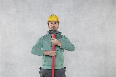 the construction worker is holding a hammer ready for demolition tasks stock image image of