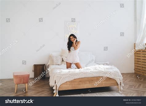 Woman Kneeling On Bed