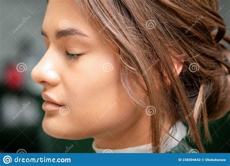 Portrait Of A Sensual Young Caucasian Woman With Closed Eyes Showing Makeup Tan On Her Face And