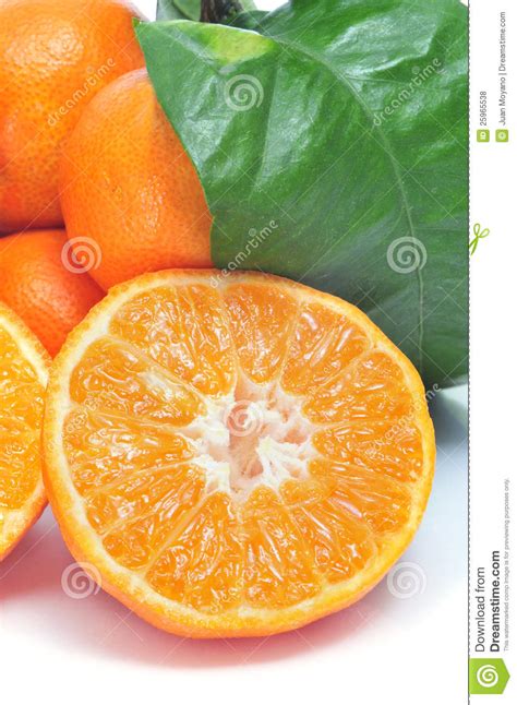 Pile Of Mandarin Oranges And Several Segments Of Peeled Mandarin Stock
