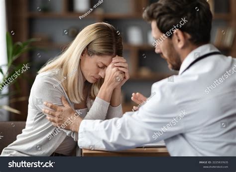 Therapist Man Comforting Upset Female Patient Stock Photo 2225937635