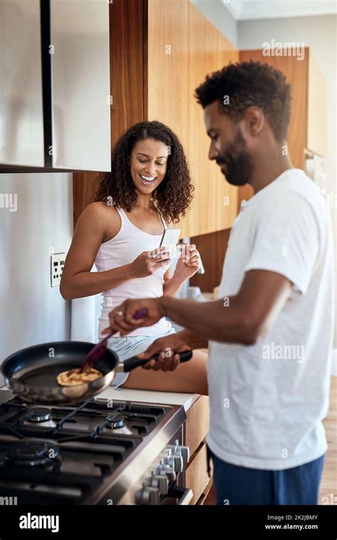 That Looks Good Cropped Shot Of A Handsome Young Man Cooking In The