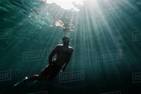 Full Length Of A Man Swimming Underwater In The Ocean Stock Photo Dissolve