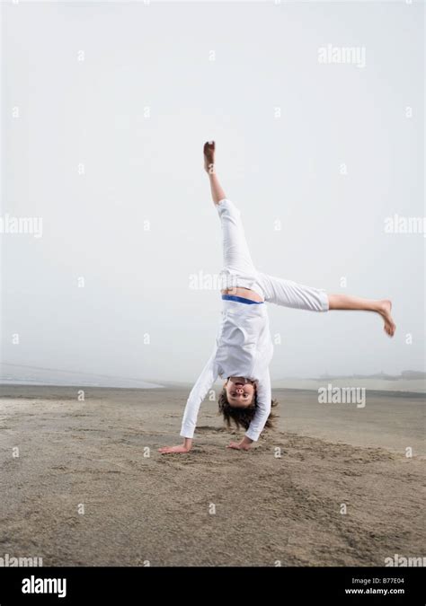 Portrait Of Girl Doing Handstand On Beach Stock Photo Alamy