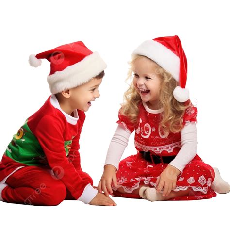صبي وفتاة يرتديان قبعة سانتا وزي عيد الميلاد يلعبان في المنزل يبتسم الأطفال الاطفال الصغار