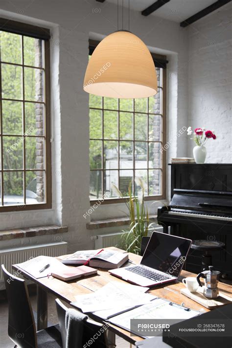 Home office with piano in background at comfortable loft apartment