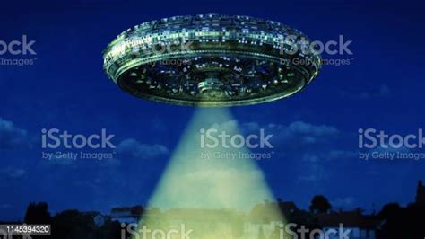 Ufo Alien Spaceship With Light Beam Hovering In The Night Sky