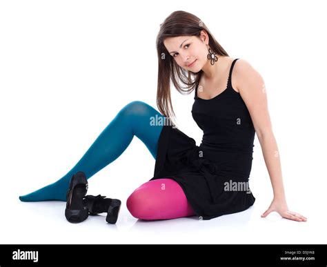 A Beautiful Young Girl Sitting On The Floor In Colored Tights Stock