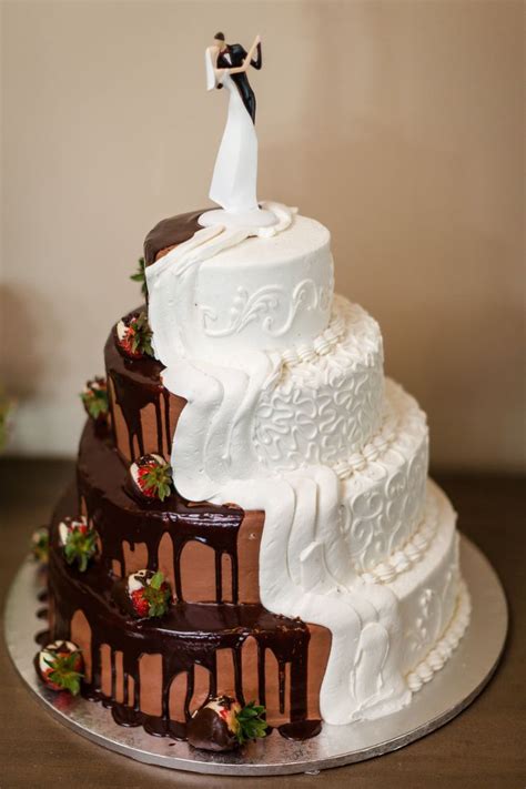a three tiered wedding cake with white frosting and chocolate icing on top