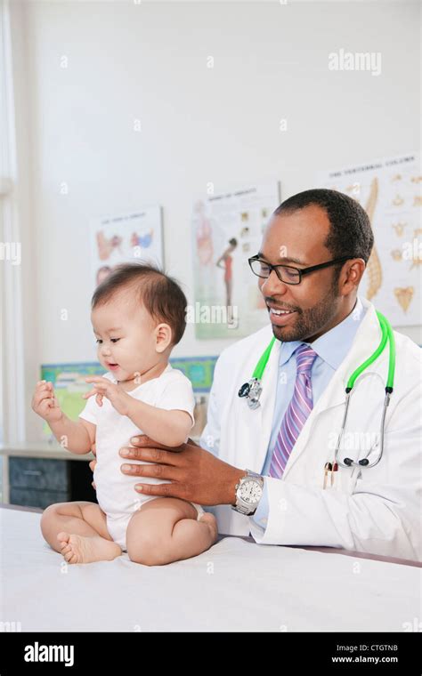 Doctor Examining Baby In Doctors Office Stock Photo Alamy