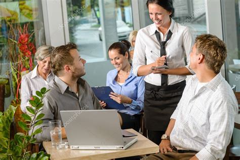 Waitress Taking Order From Businessmen In Cafe — Stock Photo