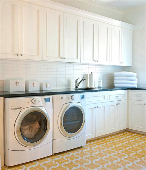 Install cabinets over the washer and dryer: Organize Your Laundry Room In Style
