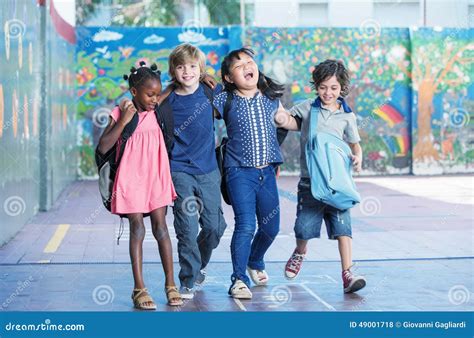 Happy Kids Embracing And Smiling In The Elementary Schoolyard I
