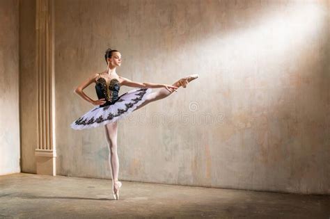 Young Ballerina In White Tutu Dancing In A Spotlight In Vintage Scene