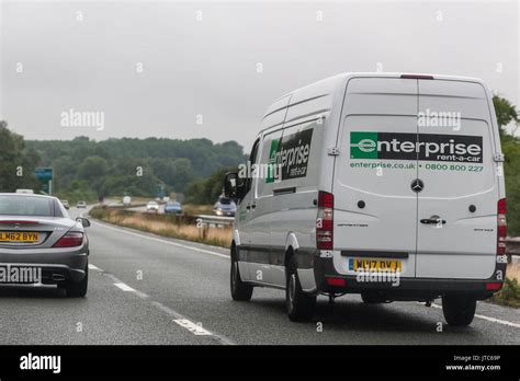 A Mercedes Sprinter enterprise rental van driving on a main road in ...