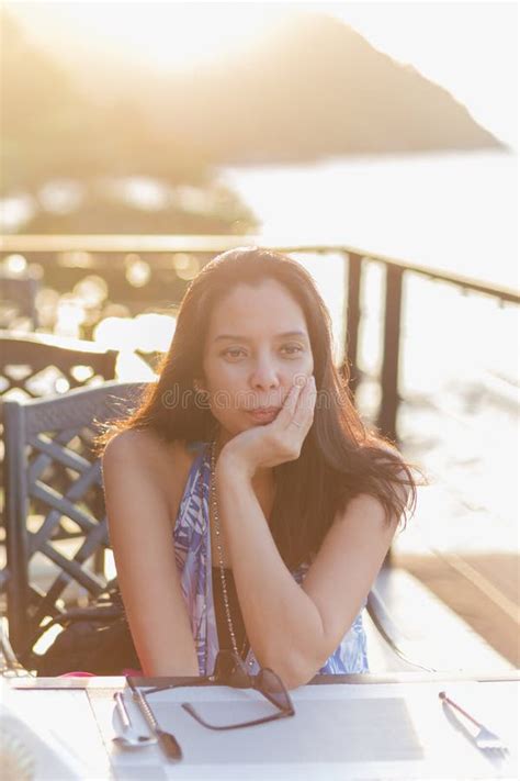 Portrait Of Beautiful Middle Age Asian Woman Sitting In Restaurant During Sunset Stock Image