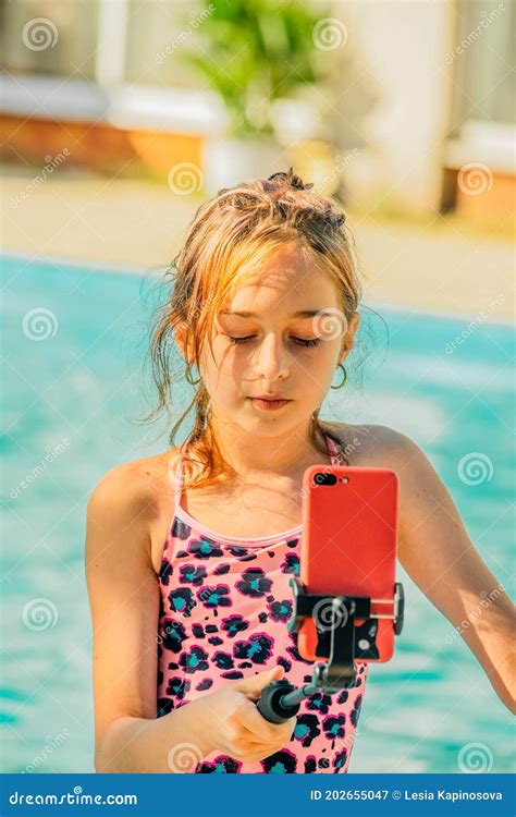 girl in a swimsuit makes a selfie near the pool smartphone teenager stock image image of
