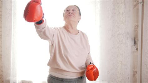premium photo portrait of funny old senior woman in boxing gloves