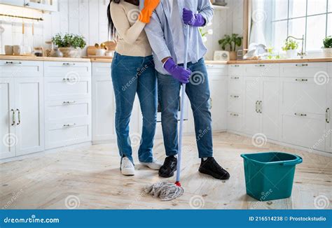 Cropped View Of African American Couple With Mop Doing Domestic Cleanup