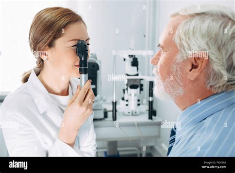 Doctor Optometrist Examining Old Mans Eyes With Ophthalmoscope Eye