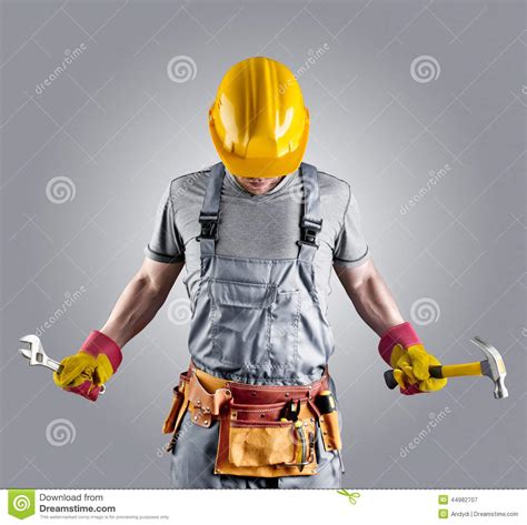 Builder In A Helmet With A Hammer And A Wrench Stock Image Image Of