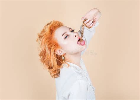 Redhead Woman Close Up Portrait With Golden Chain In Mouth Stock Image