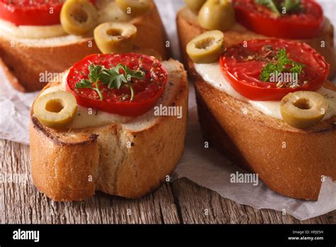 Italian Crostini With Baked Tomatoes Olives And Mozzarella Cheese
