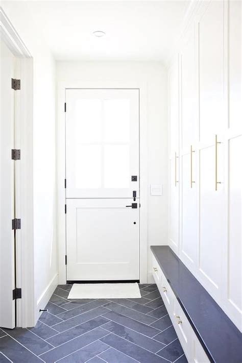 Slate Herringbone Pattern Floor Tiles In A Mudroom Contrasts White
