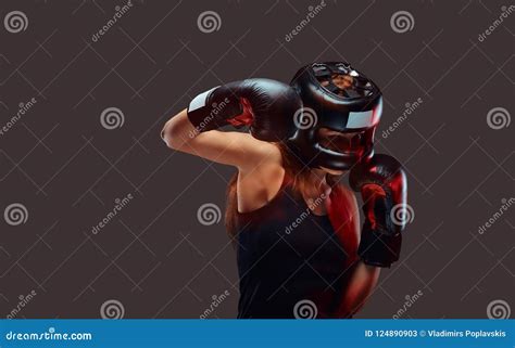 Portrait Of A Female Boxer Wearing Protective Helmet And Gloves During