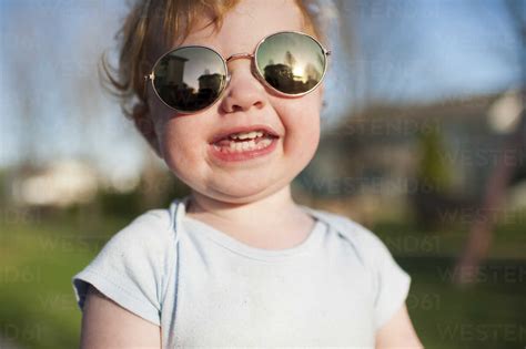 Close Up Portrait Of Cute Happy Baby Boy Wearing Sunglasses While