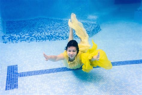 Premium Photo A Girl Wearing Fashion Dress Underwater In Blue Deep