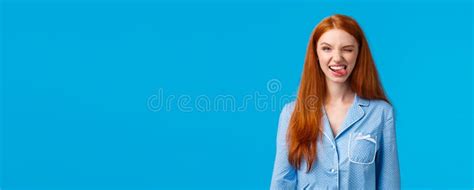 Sassy And Excited Good Looking Redhead Female In Nightwear Winking