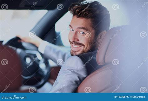 Portrait Of An Handsome Smiling Business Man Driving His Car Stock