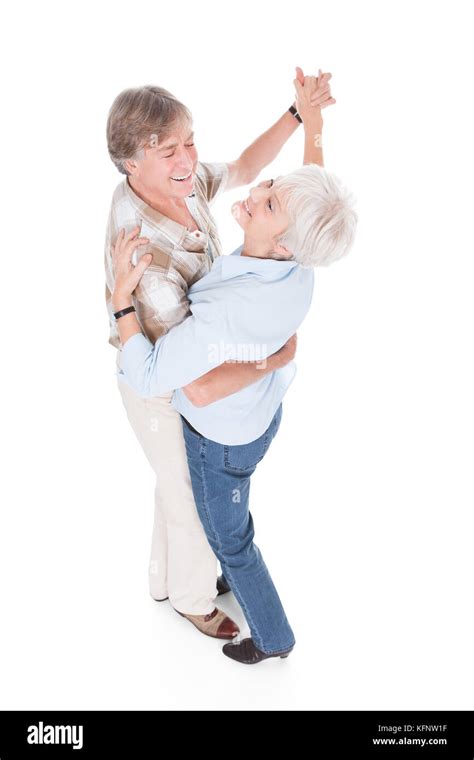 Portrait Of Happy Senior Couple Dancing Over White Background Stock