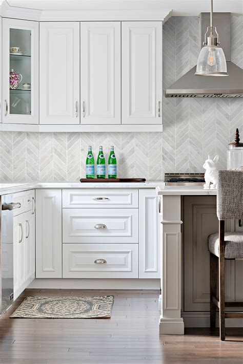 The neutralism makes it easier to pair cream with other colors in the kitchen. White Modern Marble Chevron Backsplash Tile | Backsplash.com
