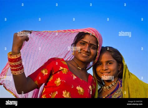 Two Friendly Indian Girls With Colorful Head Scarves And Jewellery