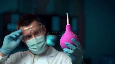 Doctor With Enema In A Laboratory A Doctor In A Medical Mask Holds An Enema Stock Video Video