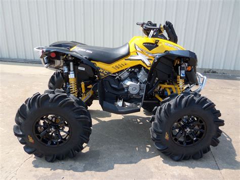 A Yellow And Black Four Wheeler Is Parked In Front Of A Building With