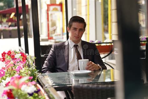 A Young Businessman Came To Lunch In A Cafe He Sits At A Table And