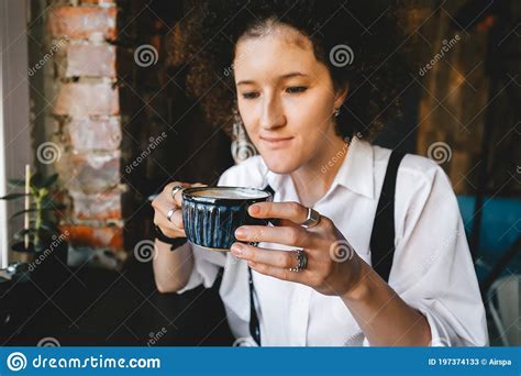 Brunette Woman With Afro Hair Sit In Cafe With Hot Coffee Stock Image