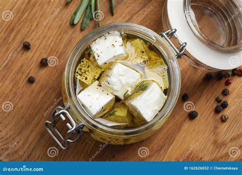 Jar With Feta Cheese Marinated In Oil On Wooden Table Pickled Food