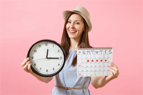 Smiling Pretty Woman In Blue Dress Hat Holding Round Clock Periods